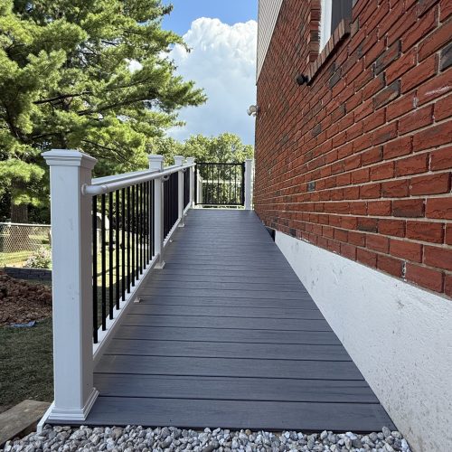 Trex composite decking with white vinyl railing and black round balusters built in Whitehall, PA.