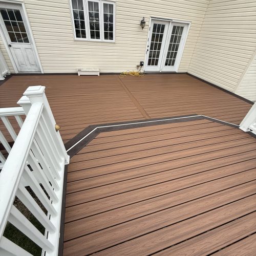 Two-tier Trex composite decking with white vinyl railing and white square balusters built in Allentown, PA.